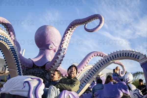 Couple of latin friends having fun in an amusement park