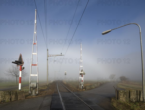 Railroad Crossing in the Fog and Blue Sky in Ticino