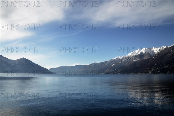 Alpine Lake Maggiore with Snow-capped Mountain and Blue Sky with Clouds in Ascona