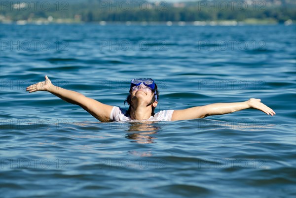 Woman with Diving Mask in the Water andArms Outstretched