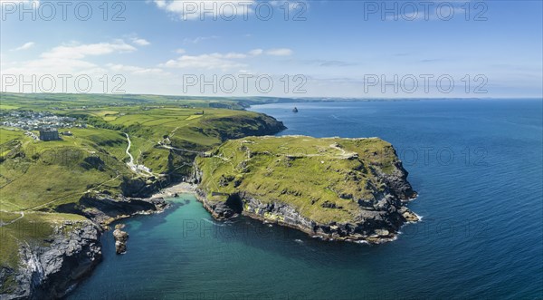 Aerial panorama of the rugged coastline on the Celtic Sea with the Tintagel Peninsula and the ruins of Tintagel Castle