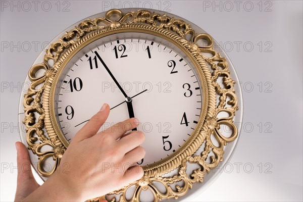 Hand in touch with a clock on a white background