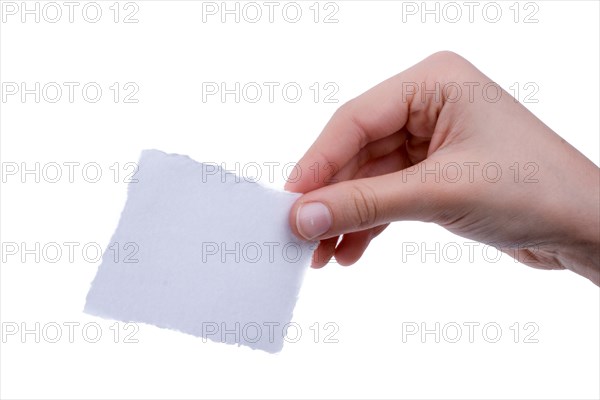 Hand holding a piece of blank torn notepaper