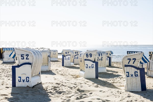 White beach chairs and mudflats