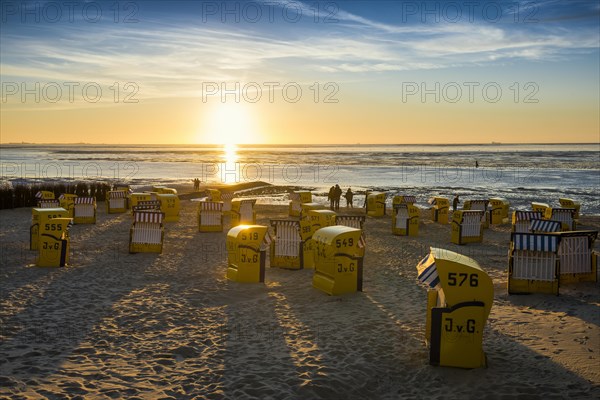 Yellow beach chairs and mudflats