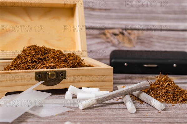 Wooden box with rolling tobacco