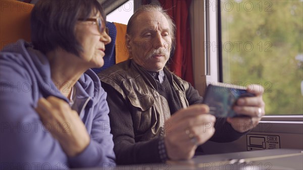 Elderly couple travel by train