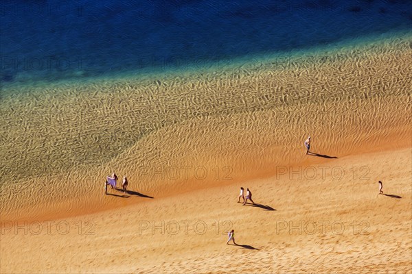 Strollers on the sandy beach Playa de Las Teresitas