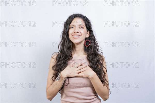 Positive woman with lovely sincere smile feeling thankful