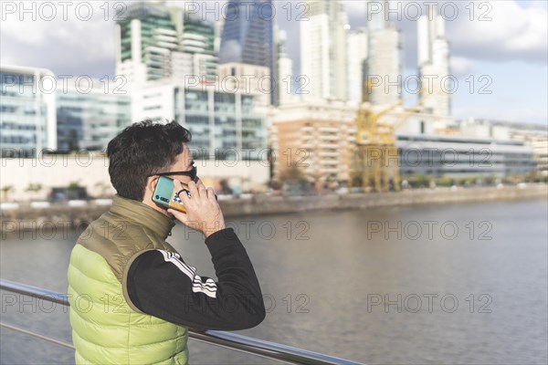 Latin man talking on the phone in Puerto Madero