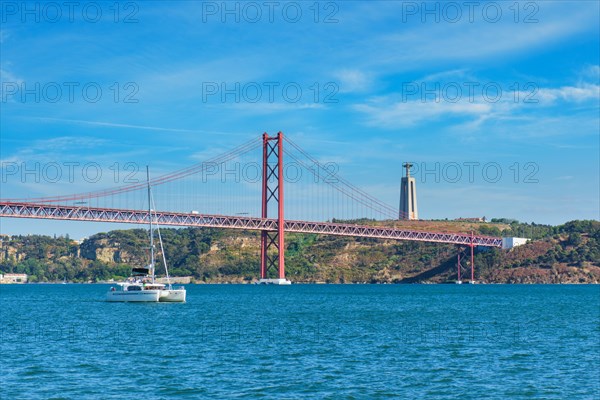 View of 25 de Abril Bridge famous tourist landmark over Tagus river