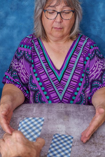 Man's hand cutting the tarot cards