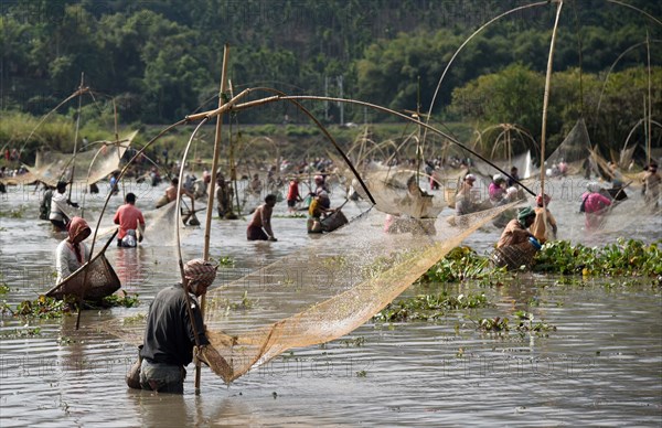 Villagers participate in a community fishing event on the occasion of Bhogali Bihu Festival at Goroimari Lake in Panbari village