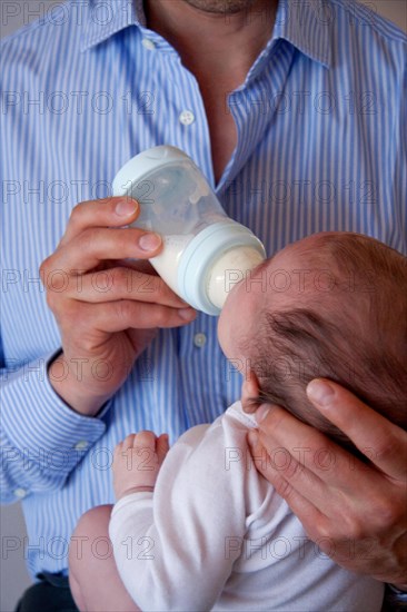 Father feeding his baby girl