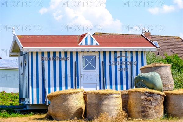 Boathouse with hay bales on the island of Langeoog