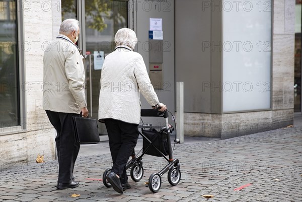 Pensioner with walker in the city centre