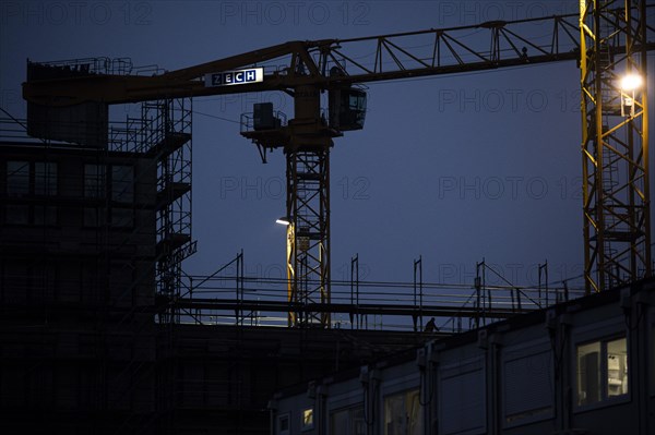 Cranes loom at a construction site in Berlin