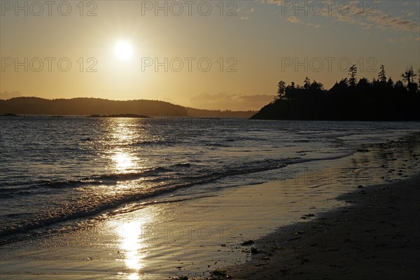 Deserted sandy beach at sunset