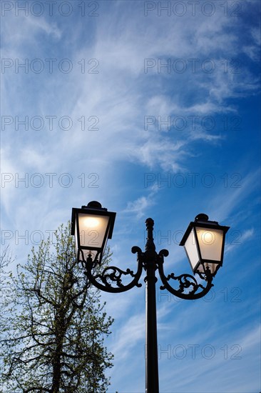 Old street lamp against a blue sky