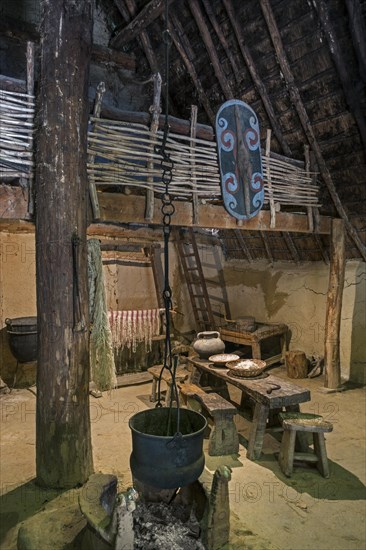 Interior of 1th century BC Gallic house showing furniture and cauldron at the open-air Archeosite and Museum of Aubechies-Beloeil