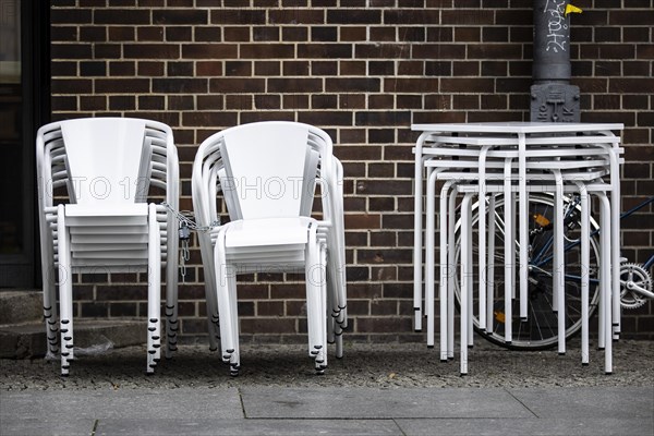 Chairs are lined up in front of a restaurant in Berlin