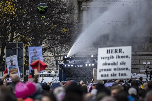 Police officers act with water cannons against demonstrators protesting against the reform of the infection protection law in Berlin