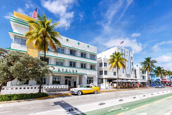 Avalon Hotel in Art Deco style architecture and vintage car on Ocean Drive in Miami Beach