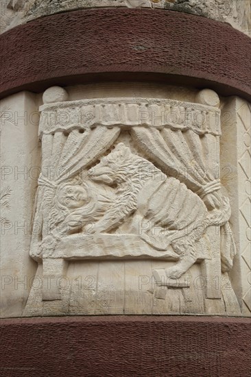 Fairytale fountain with relief of the fairytale Little Red Riding Hood with wolf and bed