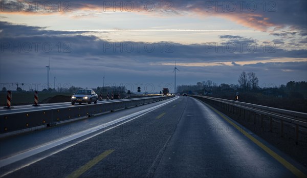 Cars drive along the A 10 motorway in Berlin at dawn. Berlin