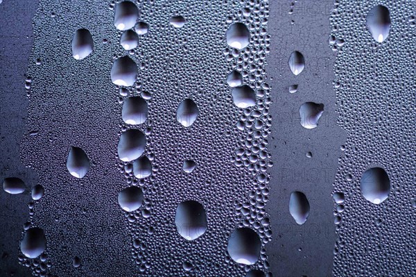 Drops stand out on a window pane in Berlin