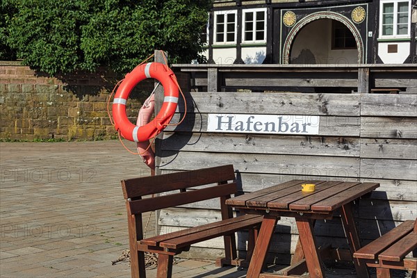 Wooden seating group on terrace of a bar