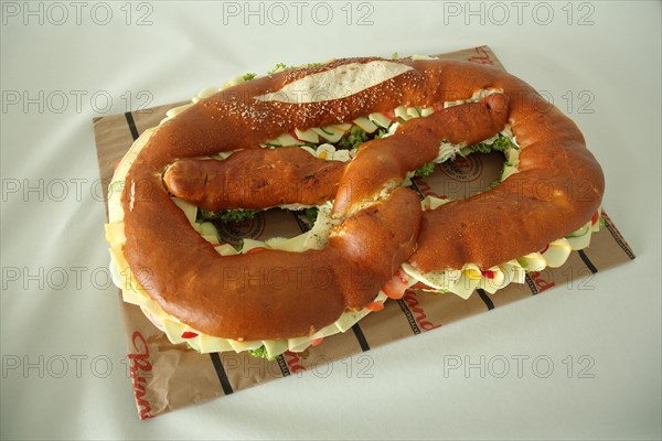 Large pretzel with cheese and sausage