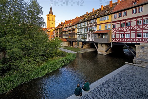 Half-timbered houses of the Kraemerbruecke with the river Gera and the Aegidienkirche