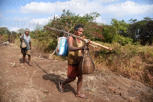 Villagers participate in a community fishing event on the occasion of Bhogali Bihu Festival at Goroimari Lake in Panbari village