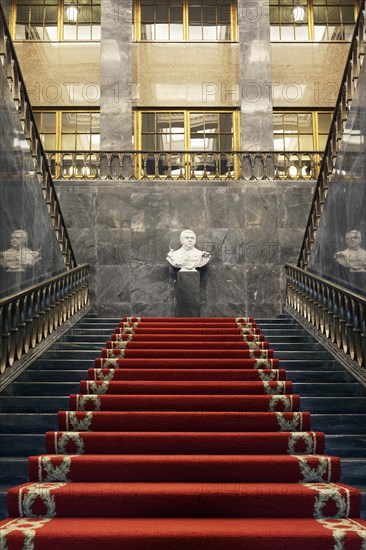 Pompous black marble staircase with red carpet