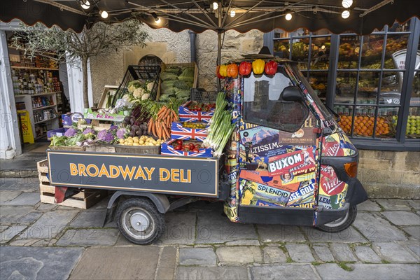 A Piaggio Ape tricycle as a vegetable stall on the high street of Broadway