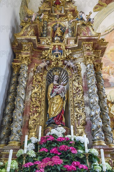 Side altar with figure of the Virgin Mary and floral decoration