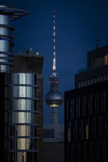 The TV tower looms behind office buildings in Berlin