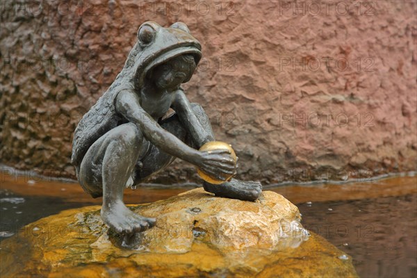 Fairytale fountain with sculpture Frog Prince and golden ball in the water