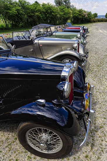 Various classic cars behind each other