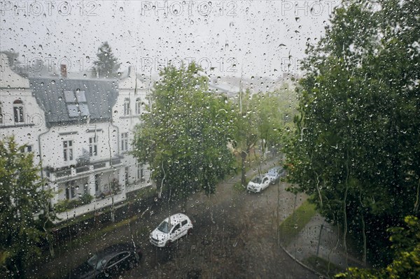 Raindrops hang on a window pane during a thunderstorm in Berlin Reinickendorf. Berlin