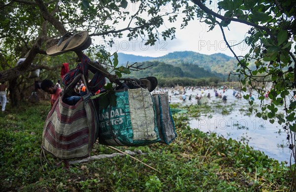 Villagers participate in a community fishing event on the occasion of Bhogali Bihu Festival at Goroimari Lake in Panbari village