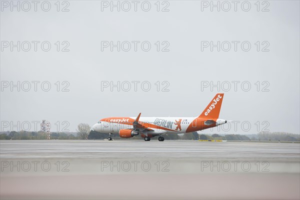 An EasyJet aircraft with the inscription Berlin taxis across the tarmac at BER Airport. Schoenefeld