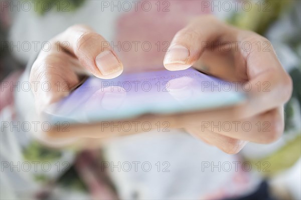 Symbolic photo on the subject of mobile phone addiction. A woman typing on a smartphone. Berlin