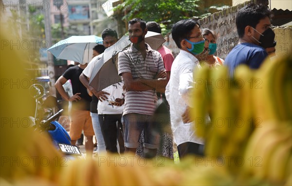 Beneficiaries wait in a queue to receive COVID-19 coronavirus vaccine dose during a vaccination campaign in Guwahati