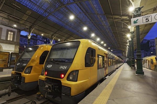 Two trains of the state railway company Comboios de Portugal at night