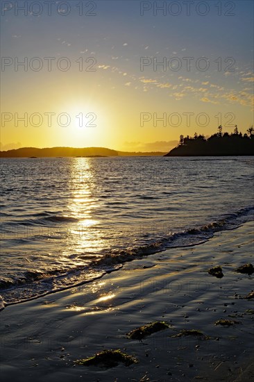 Deserted sandy beach at sunset