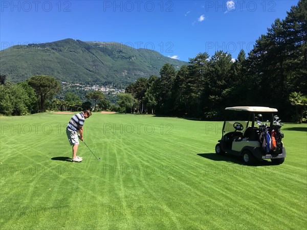 Man with Golf Cart Playing Golf on Golf Course