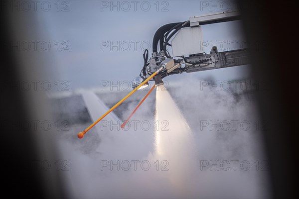 An aircraft is de-iced at Berlin-Schoenefeld BER Airport in Schoenefeld