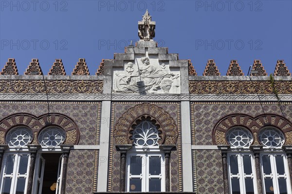 Ceramic tile facade with horseshoe window